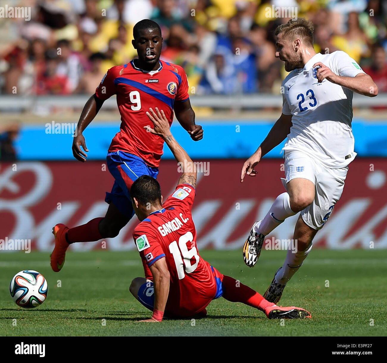 Belo Horizonte, Brazil. 24th June, 2014. England's Luke Shaw (R) vies with Costa Rica's Christian Bolanos (C) during a Group D match between Costa Rica and England of 2014 FIFA World Cup at the Estadio Mineirao Stadium in Belo Horizonte, Brazil, on June 24, 2014. England drew 0-0 with Costa Rica on Tuesday. © Qi Heng/Xinhua/Alamy Live News Stock Photo
