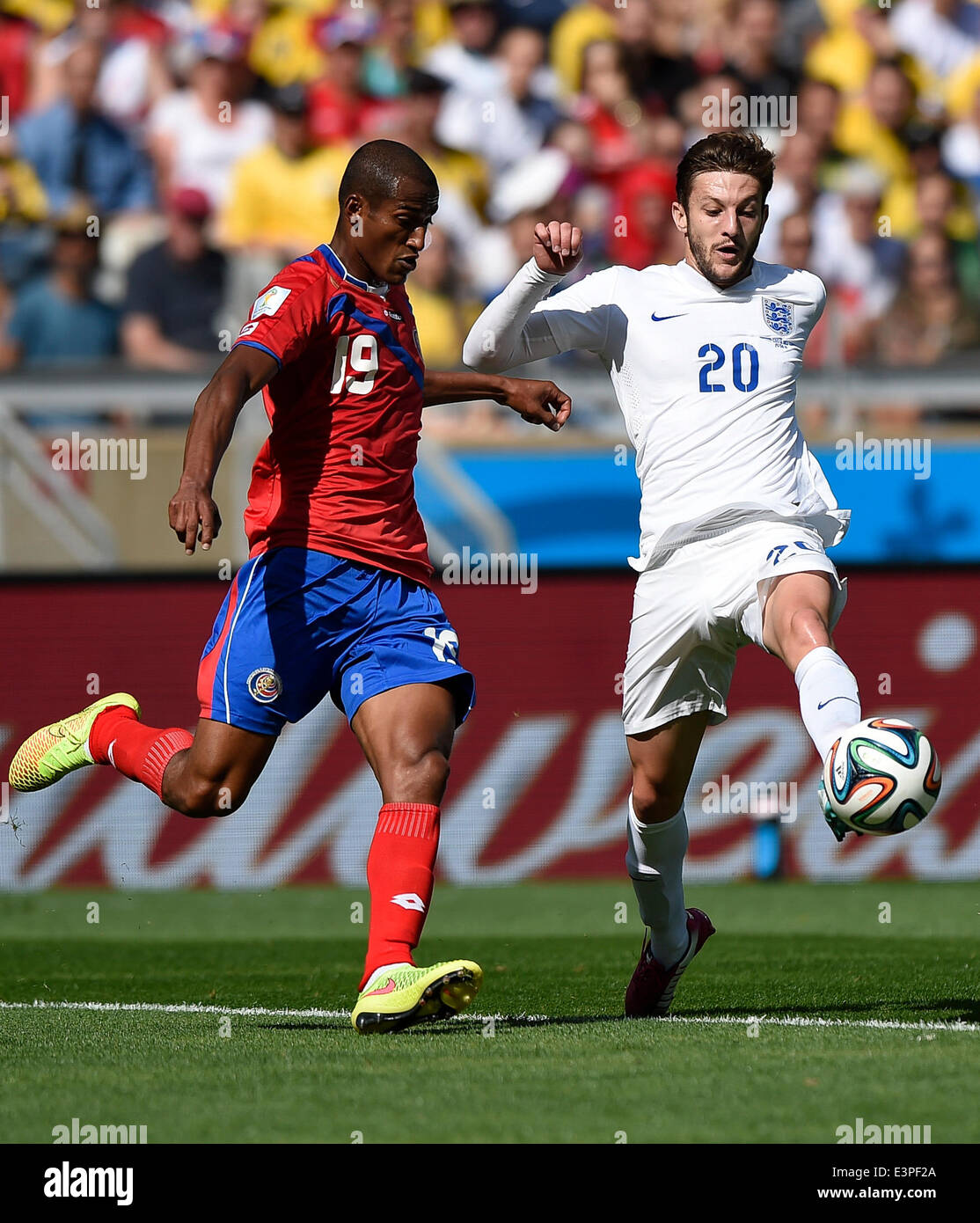 Belo Horizonte, Brazil. 24th June, 2014. England's Adam Lallana (R) vies with Costa Rica's Roy Miller during a Group D match between Costa Rica and England of 2014 FIFA World Cup at the Estadio Mineirao Stadium in Belo Horizonte, Brazil, on June 24, 2014. England drew 0-0 with Costa Rica on Tuesday. © Qi Heng/Xinhua/Alamy Live News Stock Photo