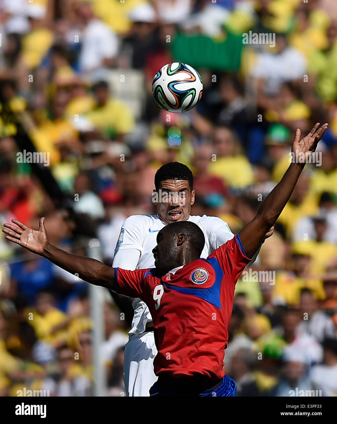 Belo Horizonte, Brazil. 24th June, 2014. Costa Rica's Joel Campbell (front) competes for a header with England's Chris Smalling during a Group D match between Costa Rica and England of 2014 FIFA World Cup at the Estadio Mineirao Stadium in Belo Horizonte, Brazil, on June 24, 2014. England drew 0-0 with Costa Rica on Tuesday. © Qi Heng/Xinhua/Alamy Live News Stock Photo