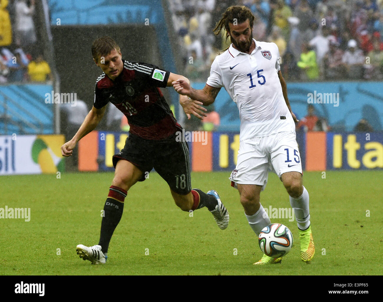 Recife, Brazil. 26th June, 2014. Germany's Toni Kroos (L) vies with Kyle Beckerman of the U.S. during a Group G match between the U.S. and Germany of 2014 FIFA World Cup at the Arena Pernambuco Stadium in Recife, Brazil, on June 26, 2014. Germany won 1-0 over the U.S. on Thursday. Germany and the U.S. enter Round of 16 from Group G. Credit:  Lui Siu Wai/Xinhua/Alamy Live News Stock Photo