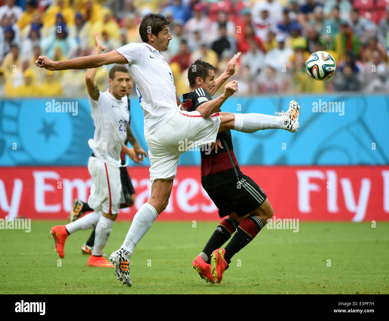 Recife, Brazil. 26th June, 2014. Omar Gonzalez (L, front) of the U.S. vies with Germany's Miroslav Klose (R, front) during a Group G match between the U.S. and Germany of 2014 FIFA World Cup at the Arena Pernambuco Stadium in Recife, Brazil, on June 26, 2014. Germany won 1-0 over the U.S. on Thursday. Germany and the U.S. enter Round of 16 from Group G. Credit:  Guo Yong/Xinhua/Alamy Live News Stock Photo