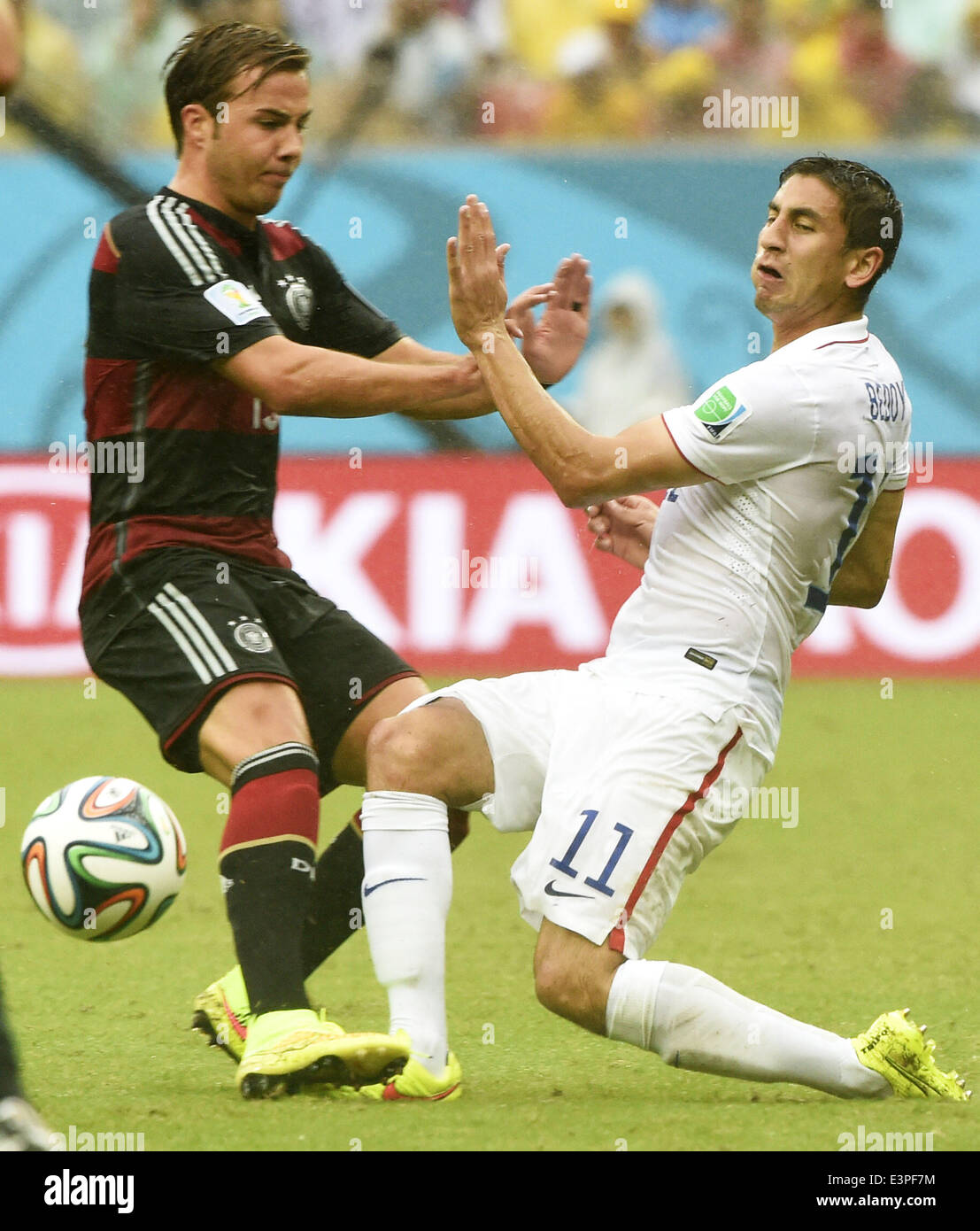 Recife, Brazil. 26th June, 2014. Alejandro Bedoya (R) of the U.S. vies with Germany's Mario Gotze during a Group G match between the U.S. and Germany of 2014 FIFA World Cup at the Arena Pernambuco Stadium in Recife, Brazil, on June 26, 2014. Germany won 1-0 over the U.S. on Thursday. Germany and the U.S. enter Round of 16 from Group G. Credit:  Lui Siu Wai/Xinhua/Alamy Live News Stock Photo