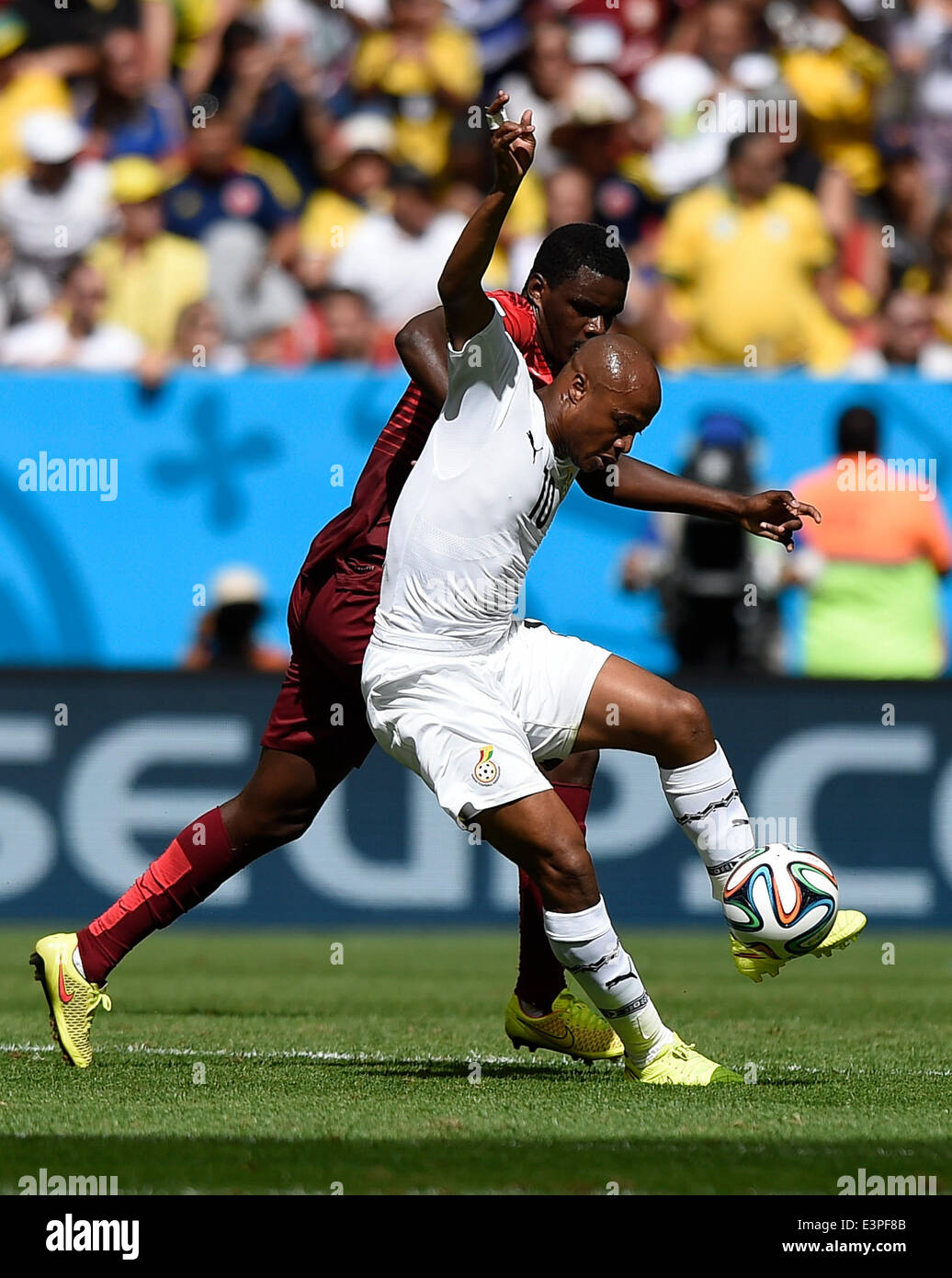 Brasilia, Brazil. 26th June, 2014. Ghana's Andre Ayew (front) vies with Portugal's William Carvalho during a Group G match between Portugal and Ghana of 2014 FIFA World Cup at the Estadio Nacional Stadium in Brasilia, Brazil, June 26, 2014. Portugal won 2-1 over Ghana on Thursday. © Qi Heng/Xinhua/Alamy Live News Stock Photo