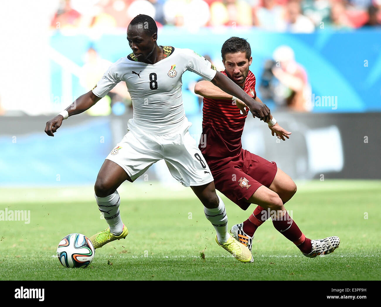Brasilia, Brazil. 26th June, 2014. Ghana's Emmanuel Agyemang-Badu (L) vies with Portugal's Joao Moutinho during a Group G match between Portugal and Ghana of 2014 FIFA World Cup at the Estadio Nacional Stadium in Brasilia, Brazil, June 26, 2014. Portugal won 2-1 over Ghana on Thursday. © Qi Heng/Xinhua/Alamy Live News Stock Photo