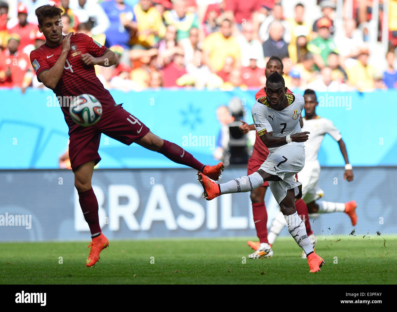 Brasilia, Brazil. 26th June, 2014. Portugal's Miguel Veloso (L) fails to block the shot by Ghana's Christian Atsu during a Group G match between Portugal and Ghana of 2014 FIFA World Cup at the Estadio Nacional Stadium in Brasilia, Brazil, June 26, 2014. Portugal won 2-1 over Ghana on Thursday. © Qi Heng/Xinhua/Alamy Live News Stock Photo