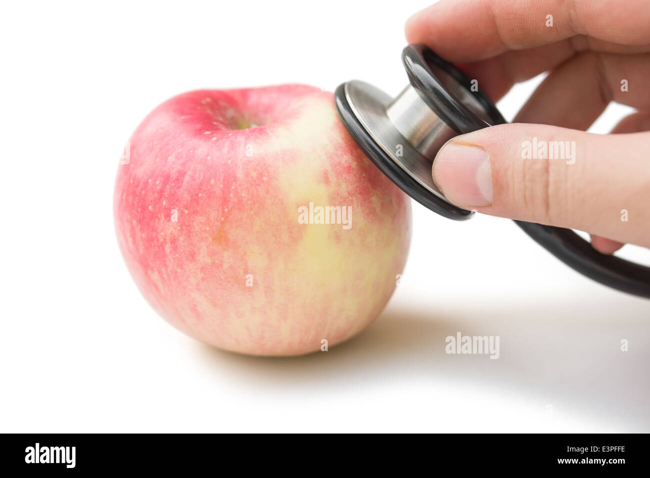 hearing an apple with stethoscope with clipping path, medical concept Stock Photo