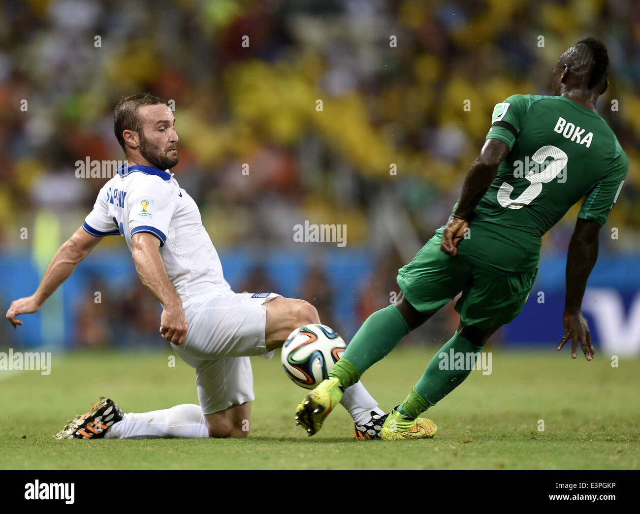 (140624) -- FORTALEZA, June 24, 2014 (Xinhua) -- Greece's Dimitris Salpingidis (L) vies with Cote d'Ivoire's Arthur Boka during a Group C match between Greece and Cote d'Ivoire of 2014 FIFA World Cup at the Estadio Castelao Stadium in Fortaleza, Brazil, June 24, 2014. (Xinhua/Yang Lei)(xzj) Stock Photo