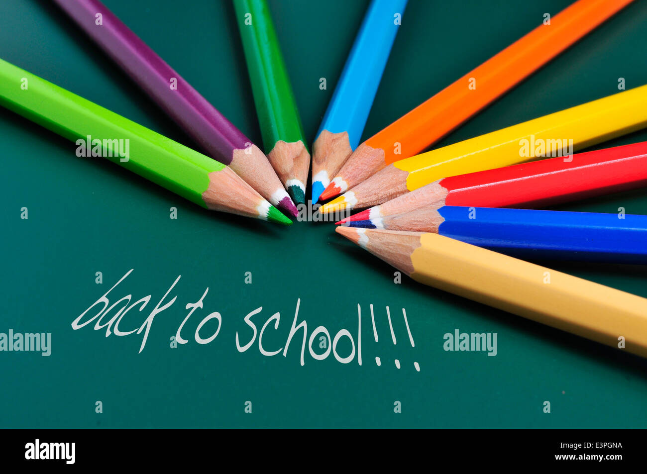 sentence back to school and some pencil crayons of different colors on