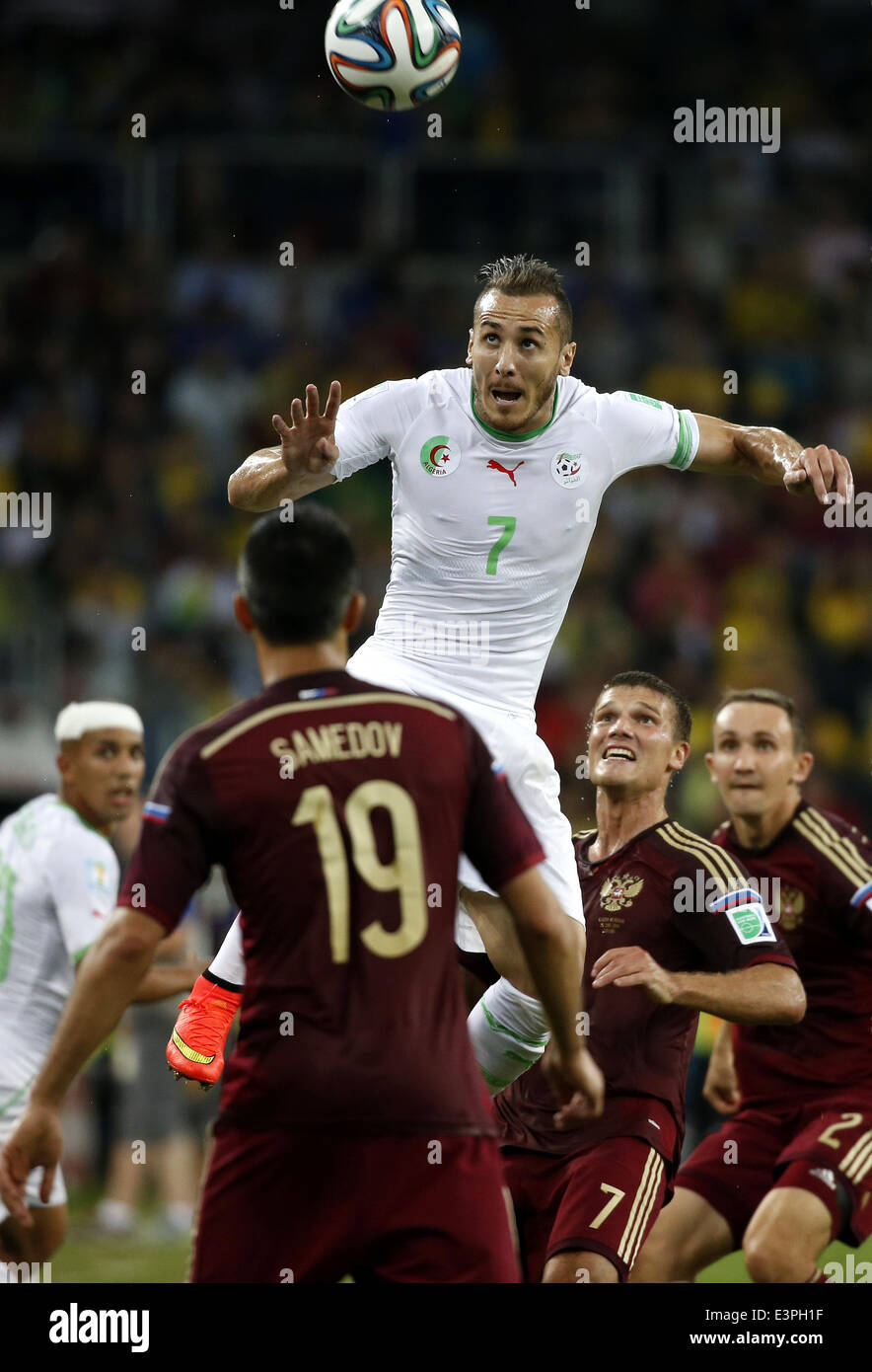 (140626) -- CURITIBA, June 26, 2014 (Xinhua) -- Algeria's Hassan Yebda (up) competes for a header during a Group H match between Algeria and Russia of 2014 FIFA World Cup at the Arena da Baixada Stadium in Curitiba, Brazil, June 26, 2014. The match ended in a 1-1 draw.Algeria enters Round of 16 after the Thursday match which ended in a 1-1 draw.(Xinhua/Liao Yujie) Stock Photo