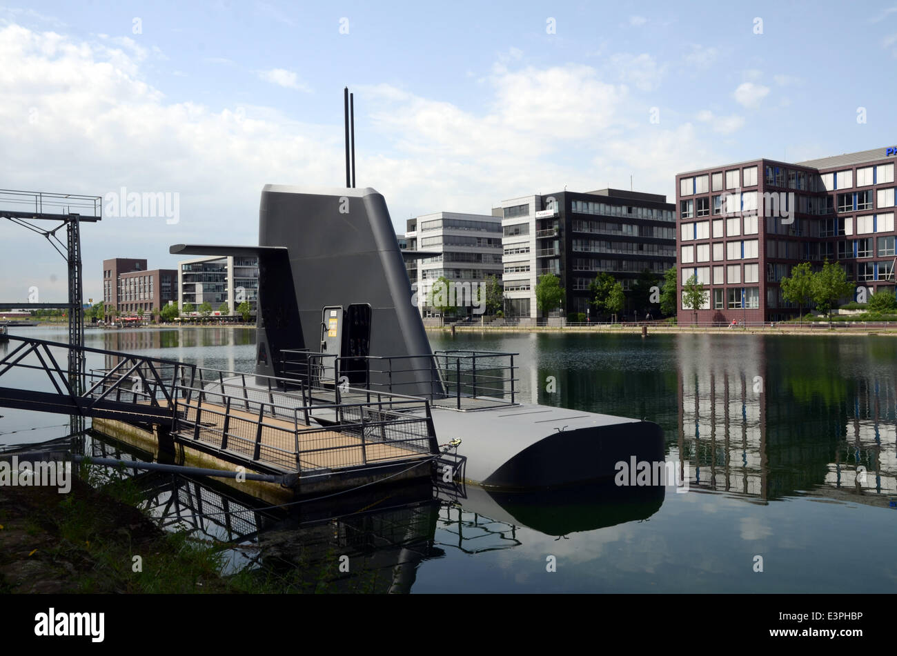 Office buildings in the Innenhafen in Duisburg, North Rhine-Westphalia. The submarine by artists Andreas Kaufmann and Hans Ulrich Reck on the left. (Photo from 22 May 2014). Stock Photo