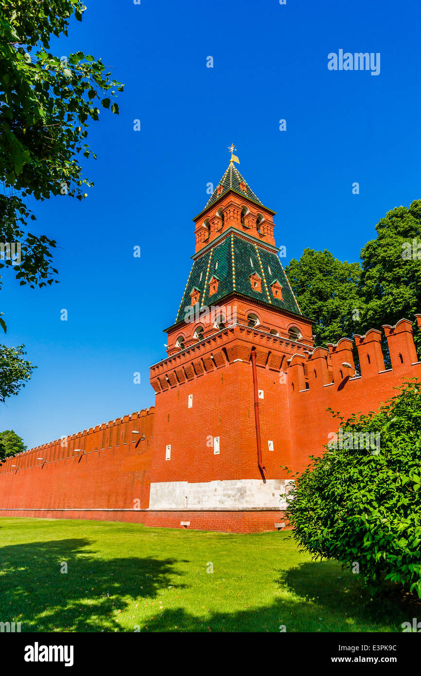 Annunciation tower of Moscow Kremlin against clear blue sky and amidst green grass and trees. Vertical format photography Stock Photo