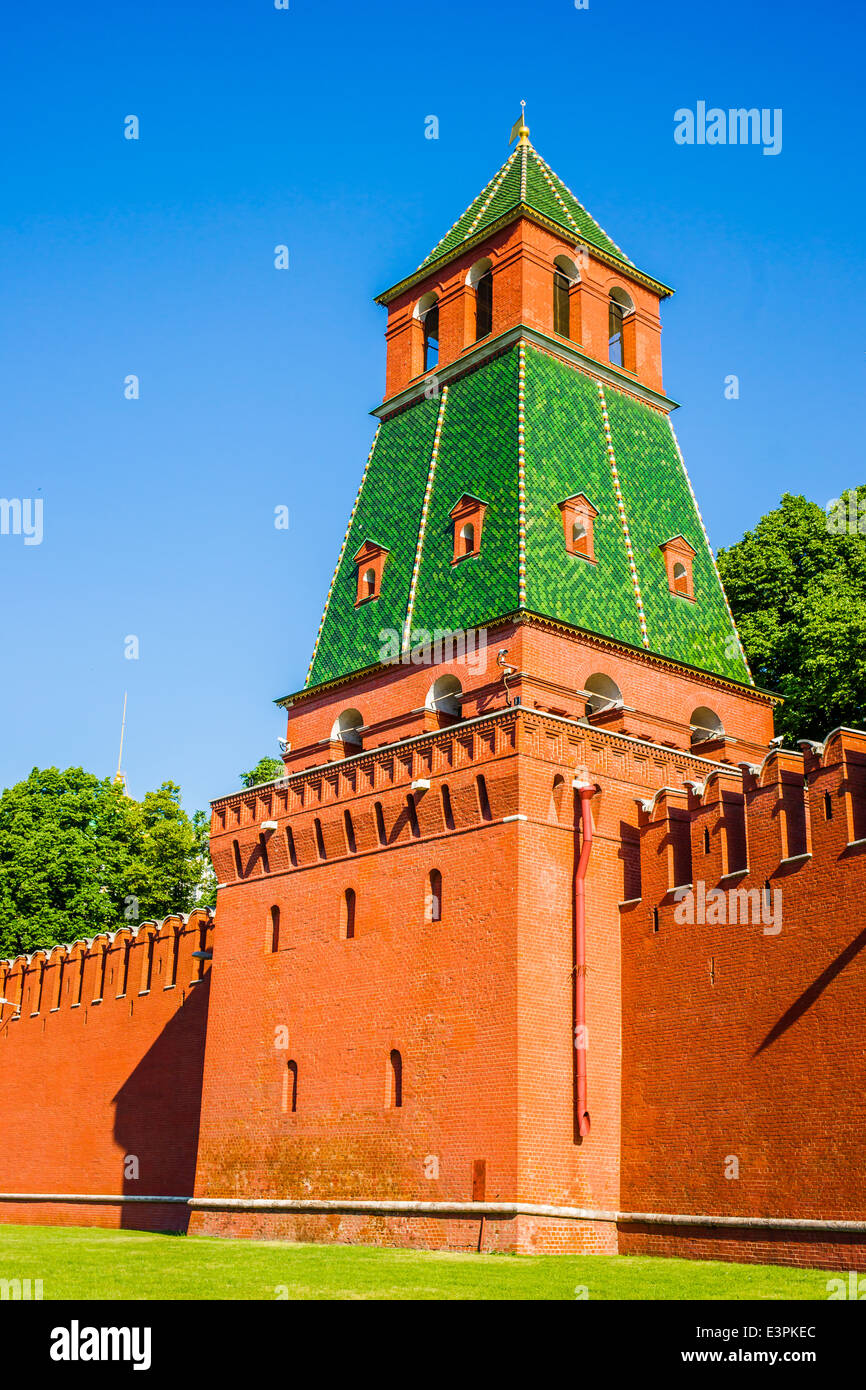 First Unnamed tower of Moscow Kremlin against clear blue sky and amidst green grass and trees Stock Photo