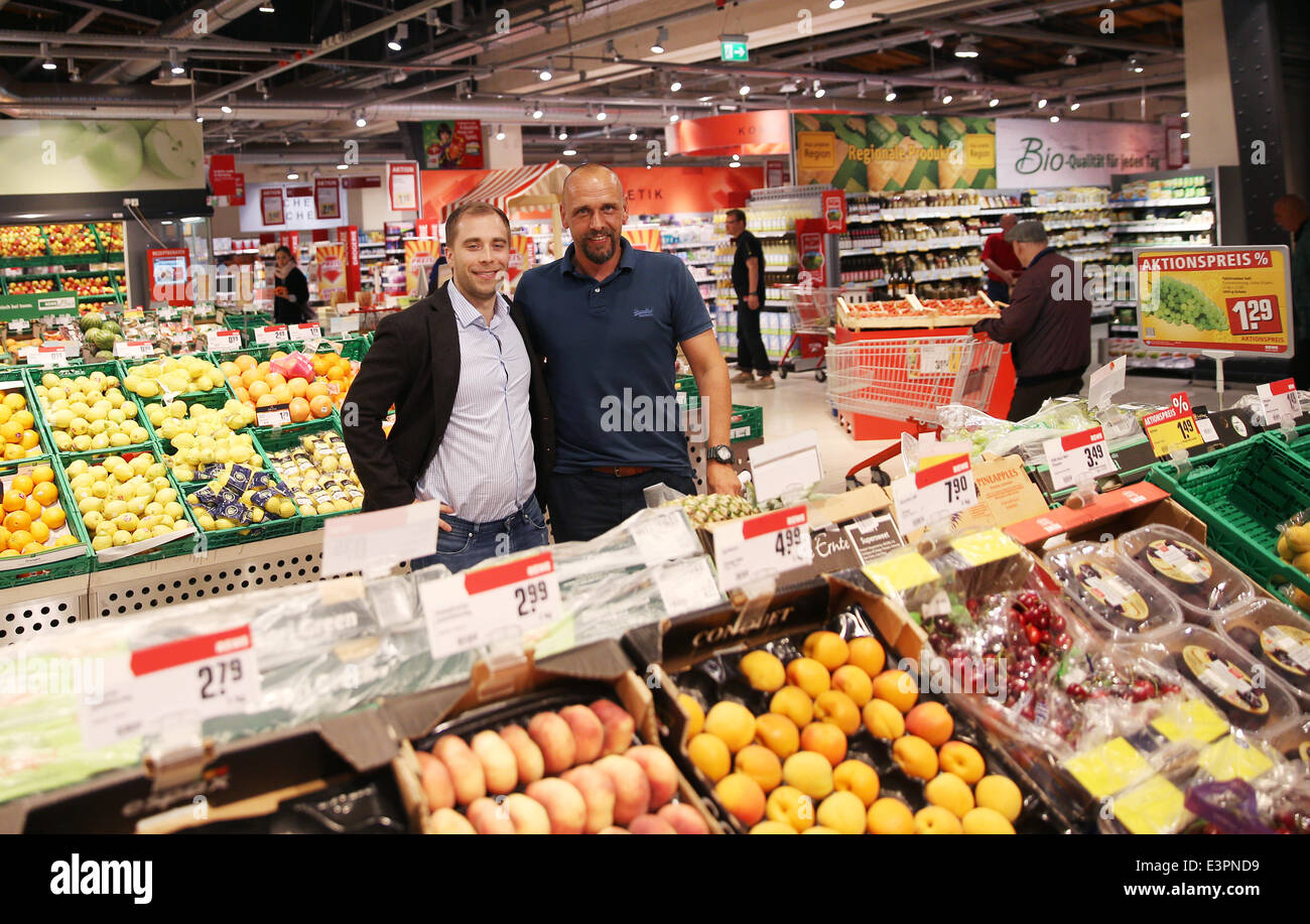 Holger Stanislawski, former coach of FC St. Pauli and former HSV pro Alexander Laas (R) stand in their supermarket in Hamburg, Germany, 27 June 2014. Stanislawski and Laas took over a Rewe store in the Winterhude neighborhood of Hamburg. Photo: CHRISTIAN CHARISIUS/dpa Stock Photo