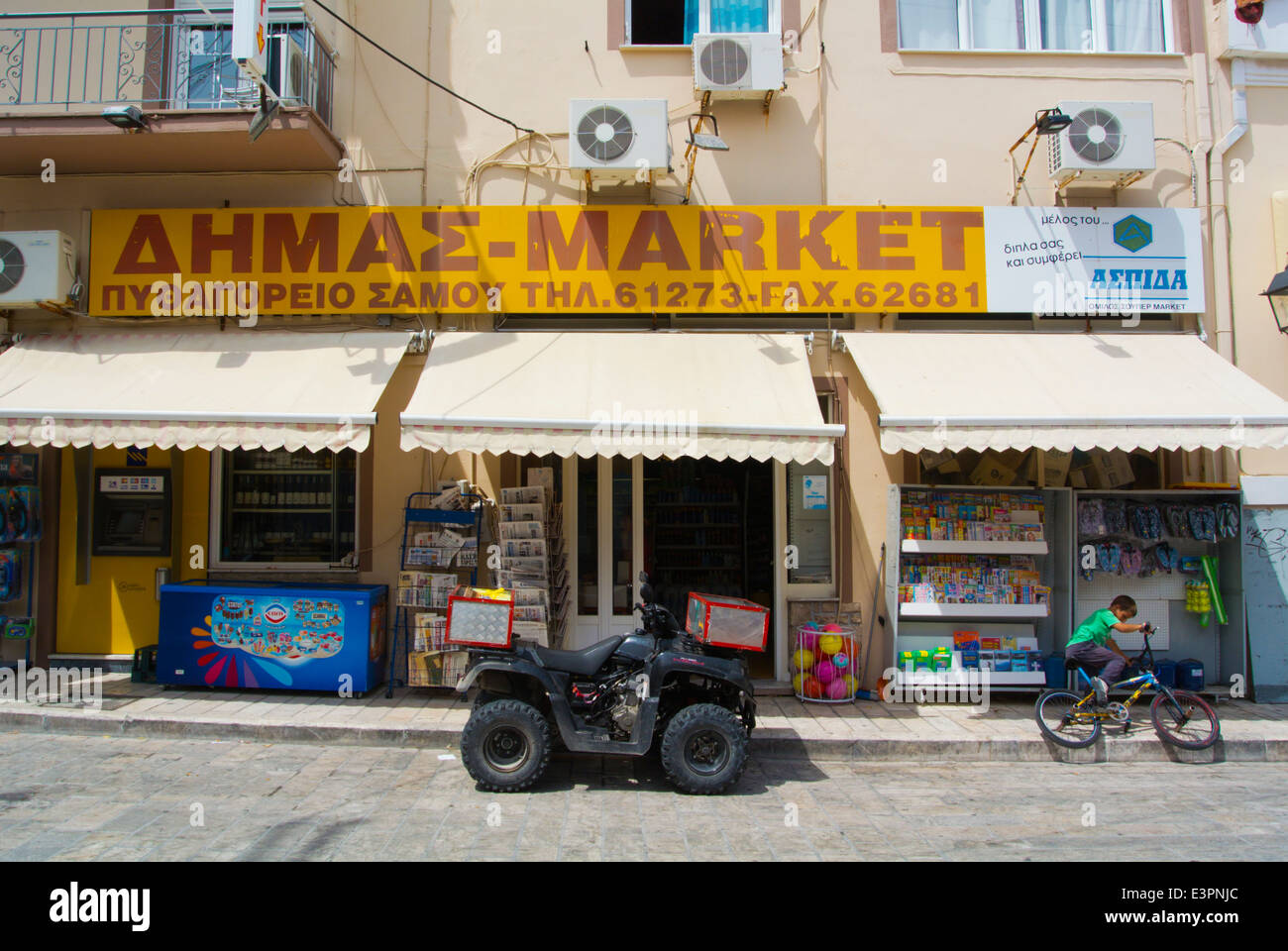Delivery quadbike outside a supermarket Logotheti street, Pythagoreio, Samos, Aegean Sea, Greece, Europe Stock Photo