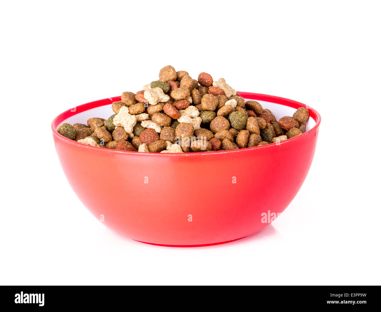 Red bowl full of dog food shot on white Stock Photo