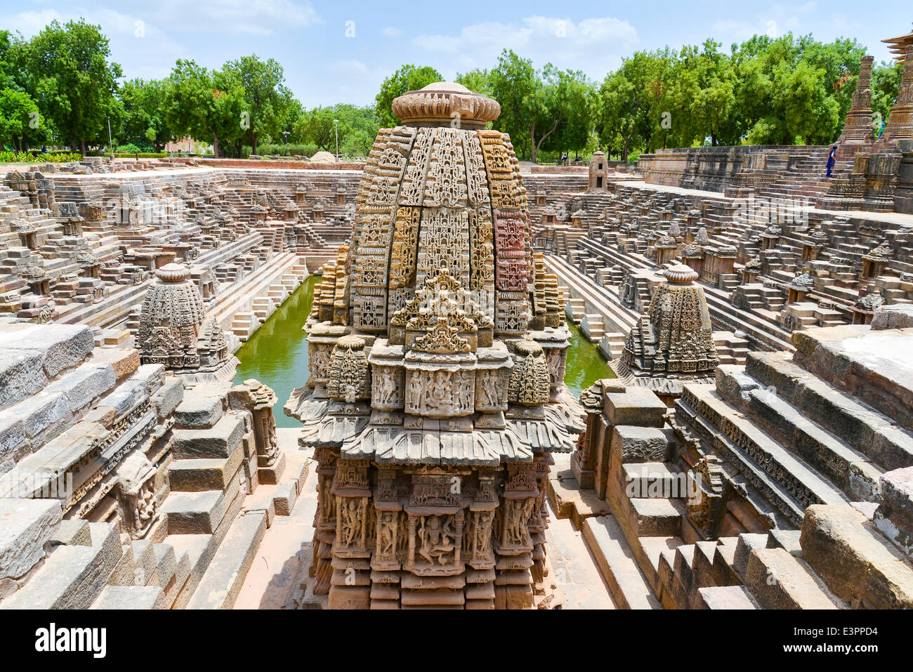 Constructed in 1026-27 A.D. during the reign of King Bhimdev I of Patan, the temple is dedicated to Surya or the Sun God. Although it bears a dilapidated look, it is still a magnificent specimen of superb artistry of Gujarat's architects of the bygone days. Modhera's sun temple is positioned in such a manner that at the equinoxes the rising sun strikes the images in the sanctuary.  It also incorporates an amusement park, a museum, a cafeteria, picture gallery and library.  The canvas on the walls and pillars depict the incidents from the Ramayan and the Mahabharat, and forms of gods and goddes Stock Photo