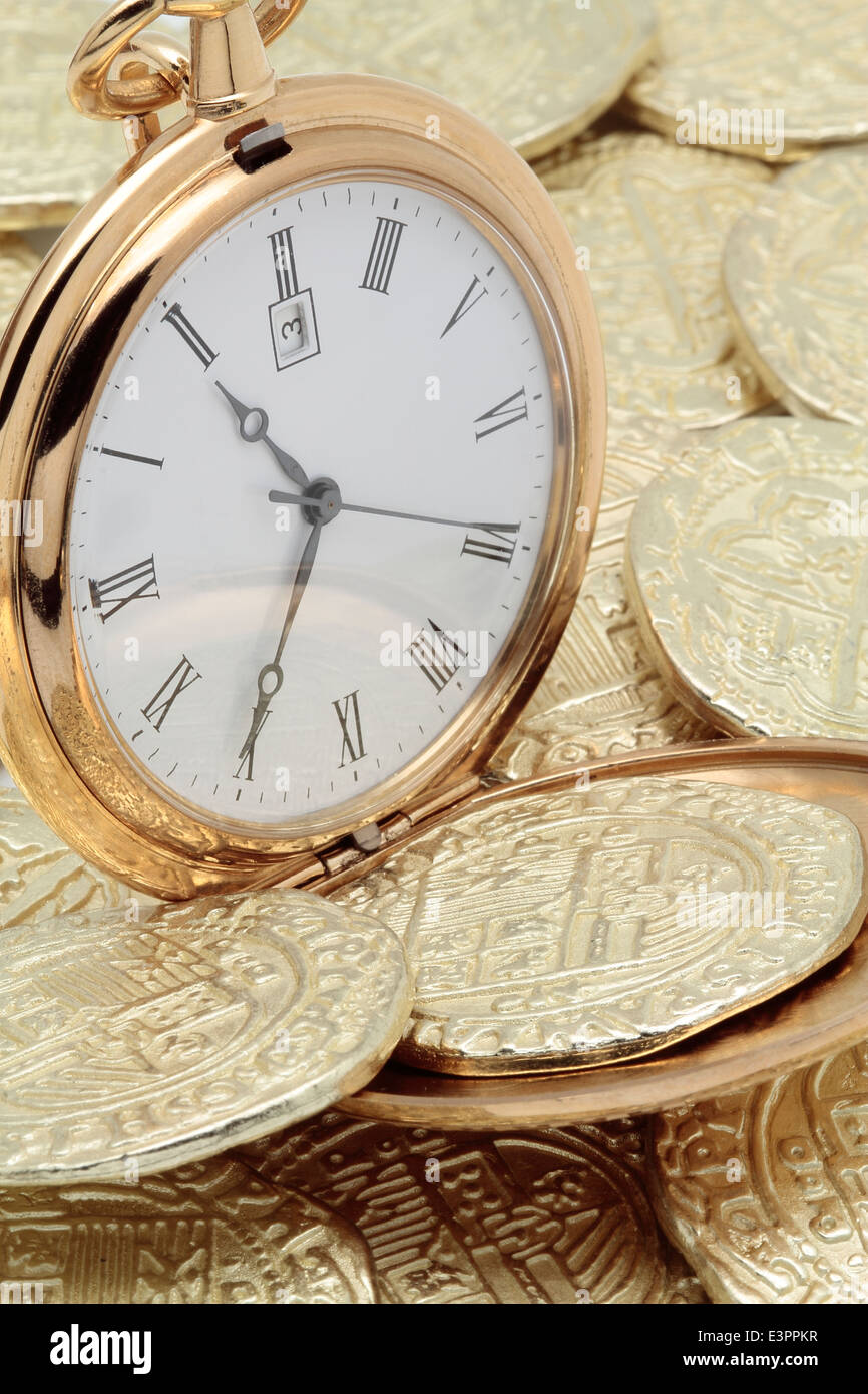 pocket watch with some gold doubloons Stock Photo
