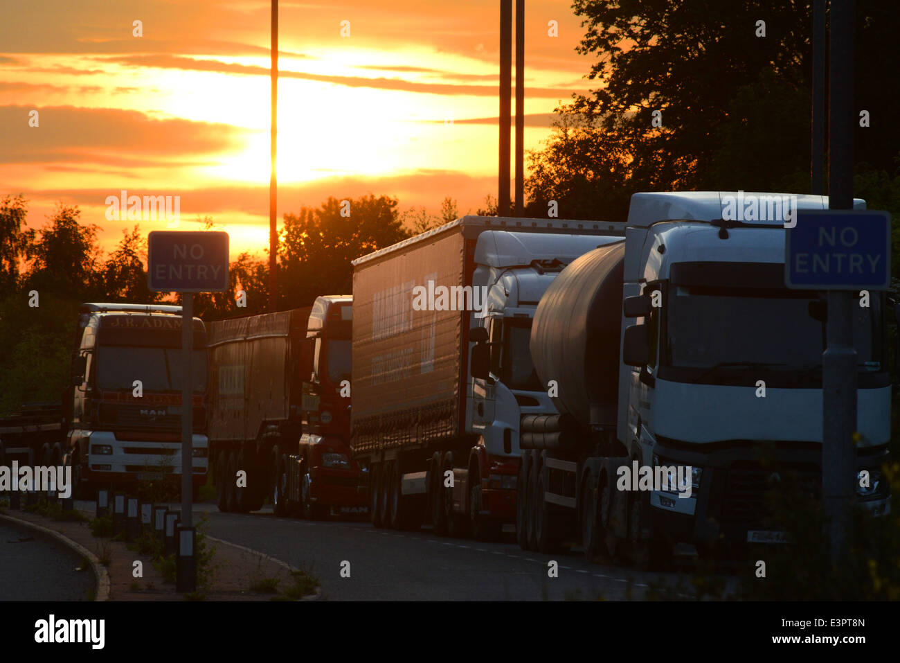 parked lorrys at sunset at overnight rest stop for drivers near selby united kingdom Stock Photo