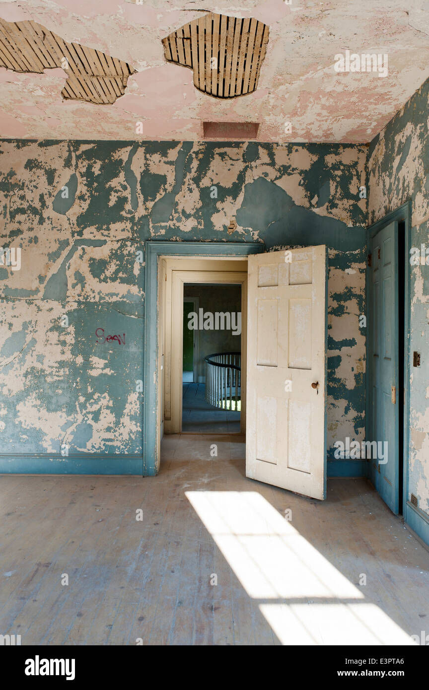 Open Door In Room With Cracked And Peeling Wall Paint And
