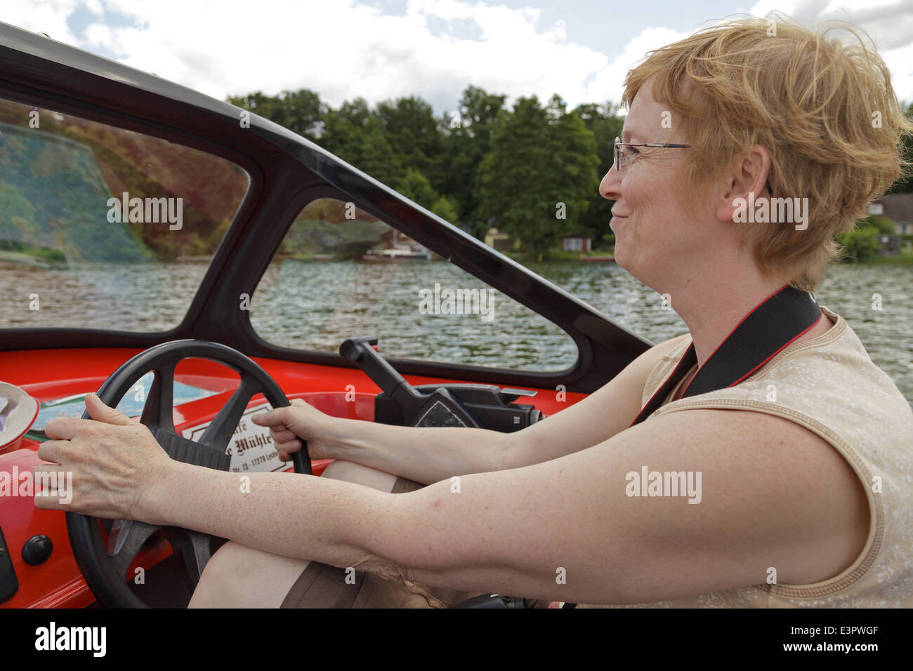 Woman driving boat hi-res stock photography and images - Alamy
