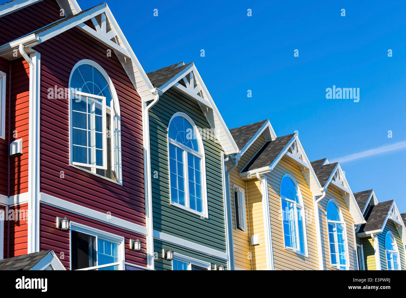A row of colorful new townhouses or condominiums. Stock Photo