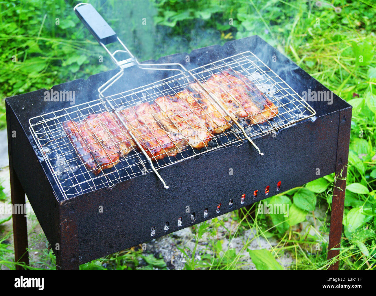 Grilled pork ribs on barbecue stand Stock Photo Alamy