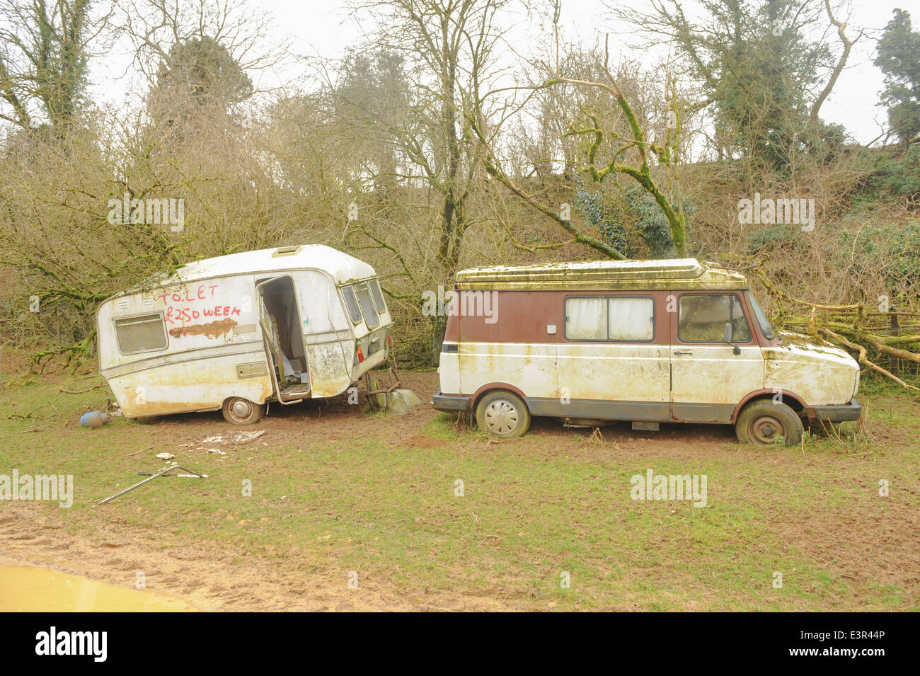 Abandoned Camper van and caravan in a field close to Winchcombe in the Cotswolds, Gloucestershire, England, UK Stock Photo