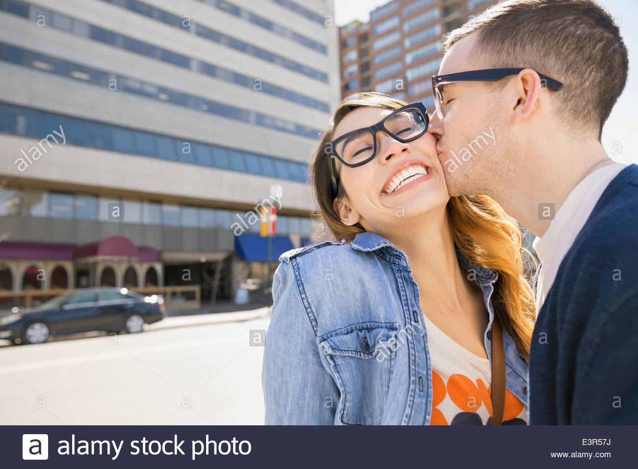 Man kissing woman cheek sunny hi-res stock photography and images - Alamy