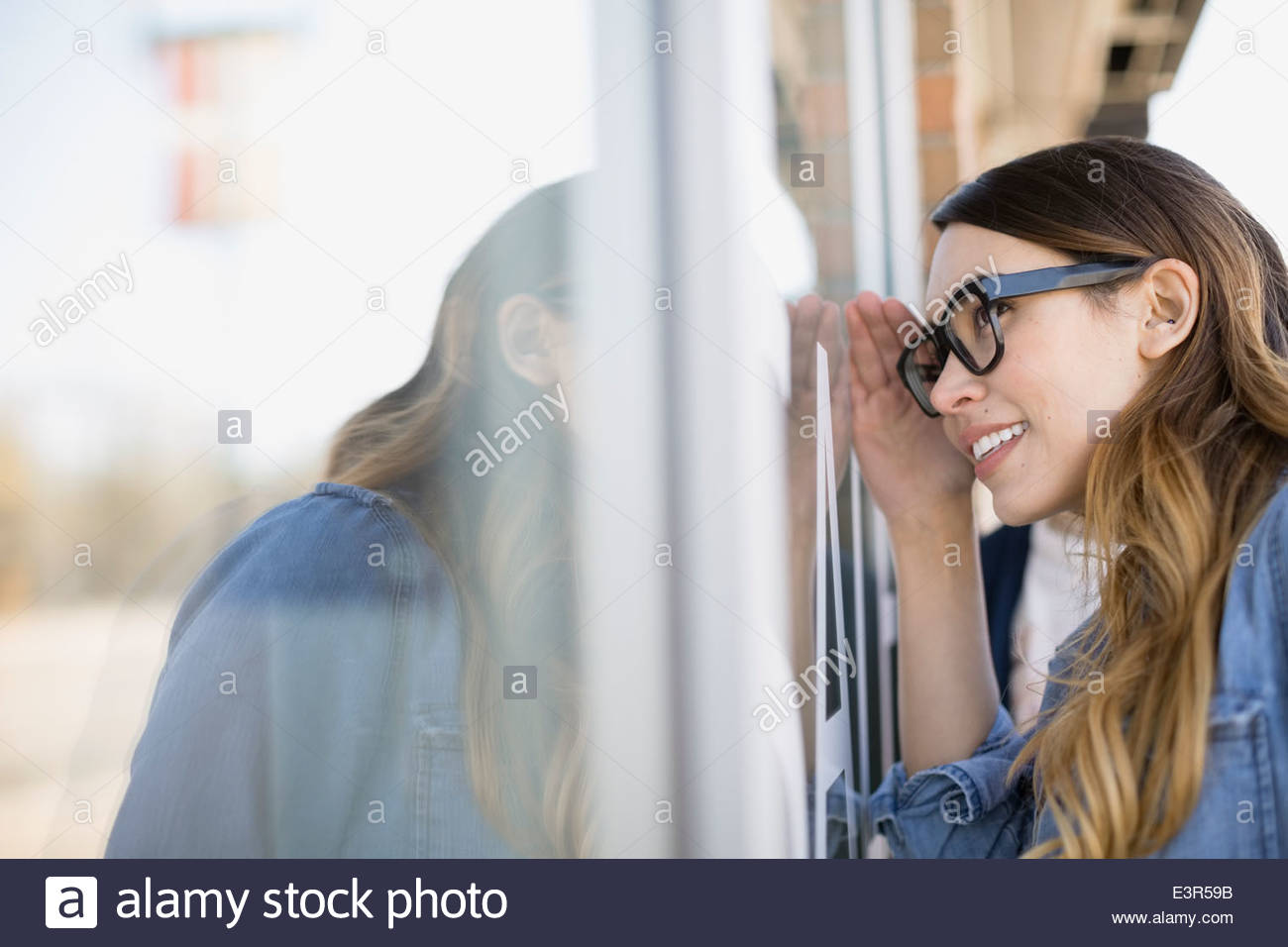 Woman window shopping at storefront Stock Photo
