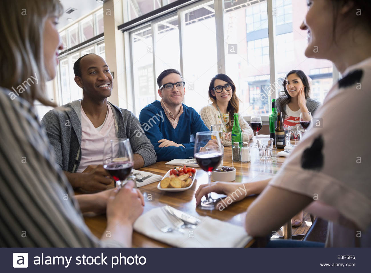 Friends drinking beer and wine at bistro table Stock Photo Alamy