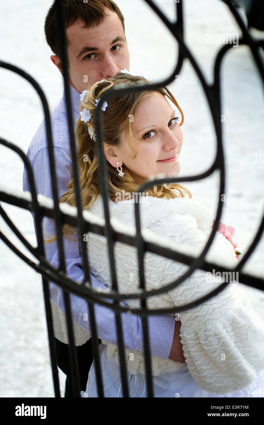 Caucasian newlyweds embrace outdoor in the winter Stock Photo