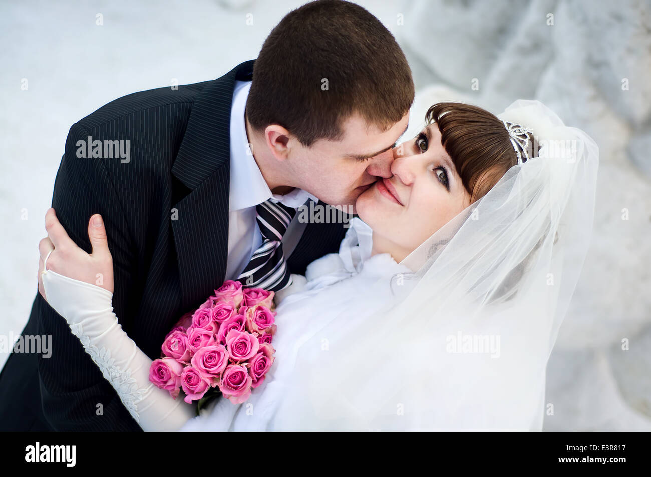 European newlyweds embrace outdoor in the winter Stock Photo