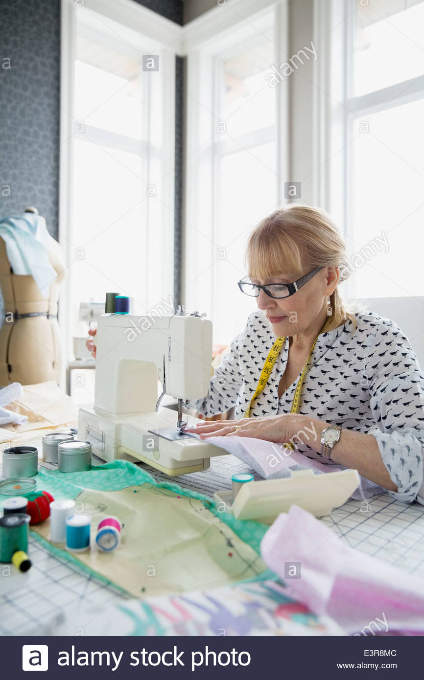 Seamstress working at sewing machine Stock Photo Alamy