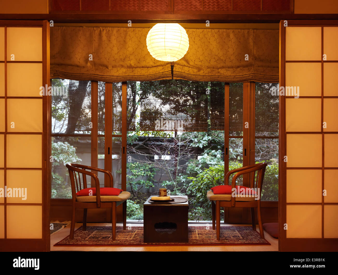 License available at MaximImages.com Traditional Japanese room interior details with a garden view at a ryokan in Kyoto, Japan. Stock Photo
