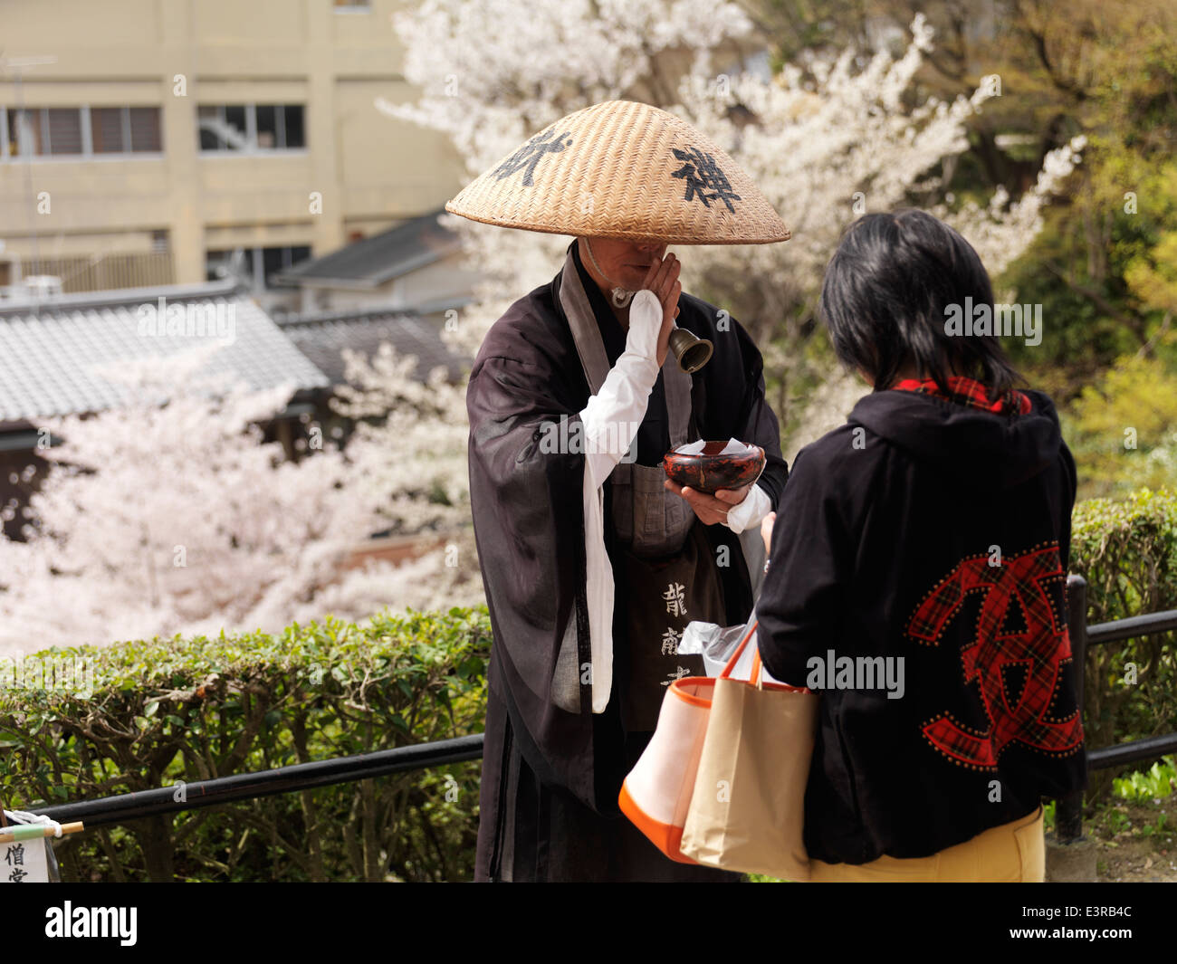 Mendicant Buddhist monk accepting donations. Kyoto, Japan. Stock Photo