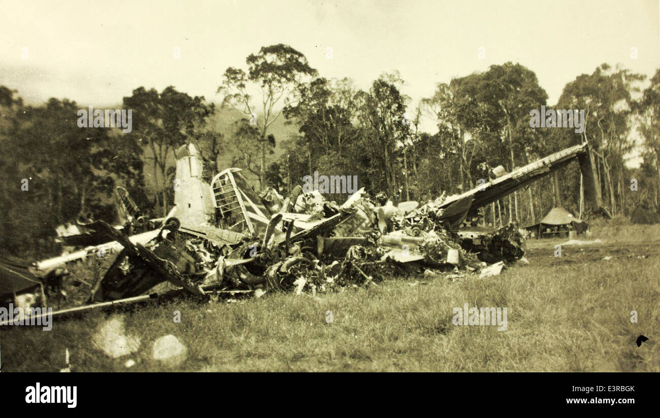 This image documents an aircraft accident, capturing the aftermath of a ...