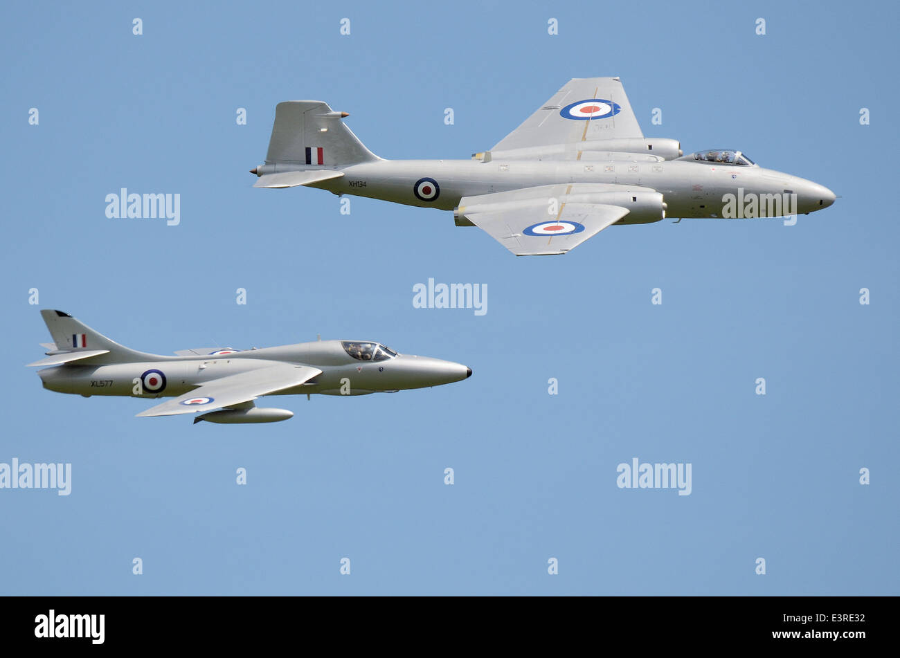Canberra and Hunter vintage jets flying in blue sky. Hawker Hunter and English Electric Canberra vintage planes of Midair Squadron Stock Photo