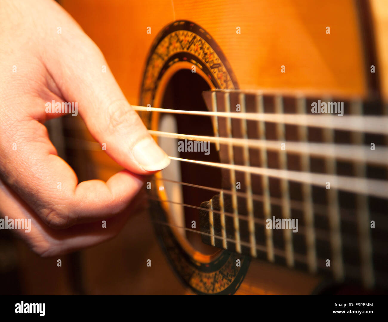 Fingers playing an acoustic guitar Stock Photo Alamy
