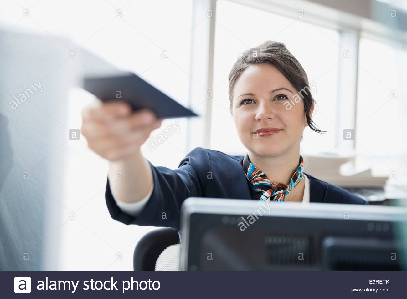 Airport customer service representative holding passport Stock Photo