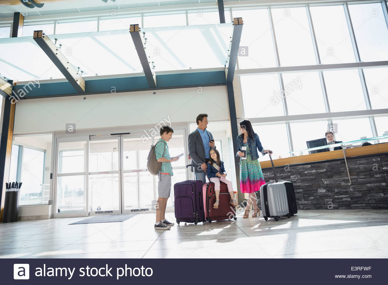 Family with suitcases arriving at airport Stock Photo
