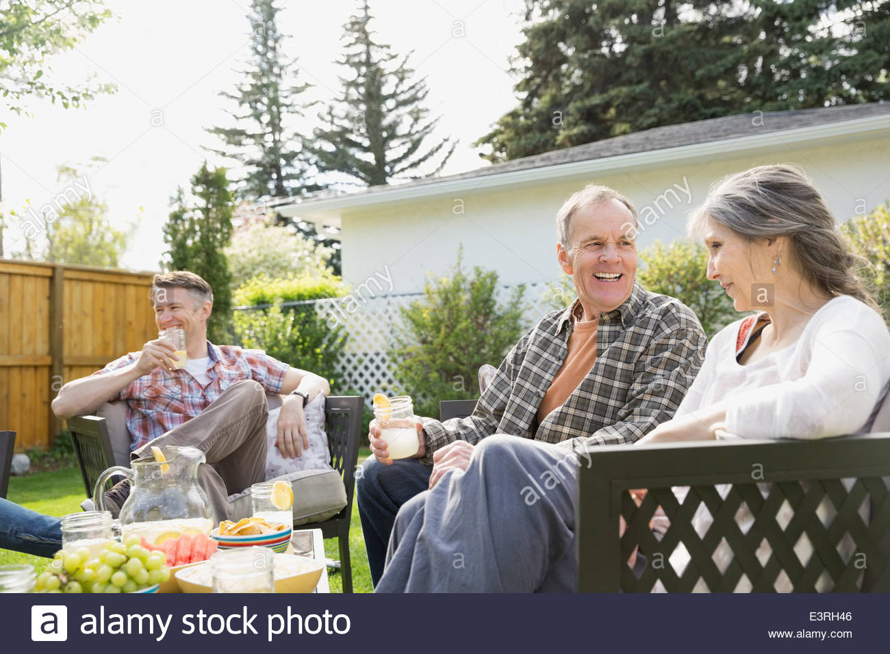 Senior couple relaxing in backyard Stock Photo