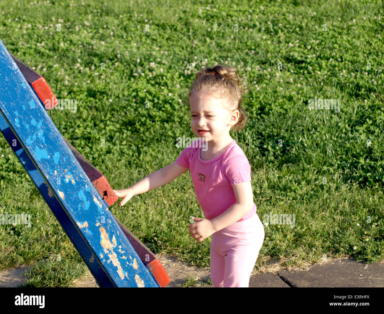 adorable little girl playing in the park Stock Photo - Alamy