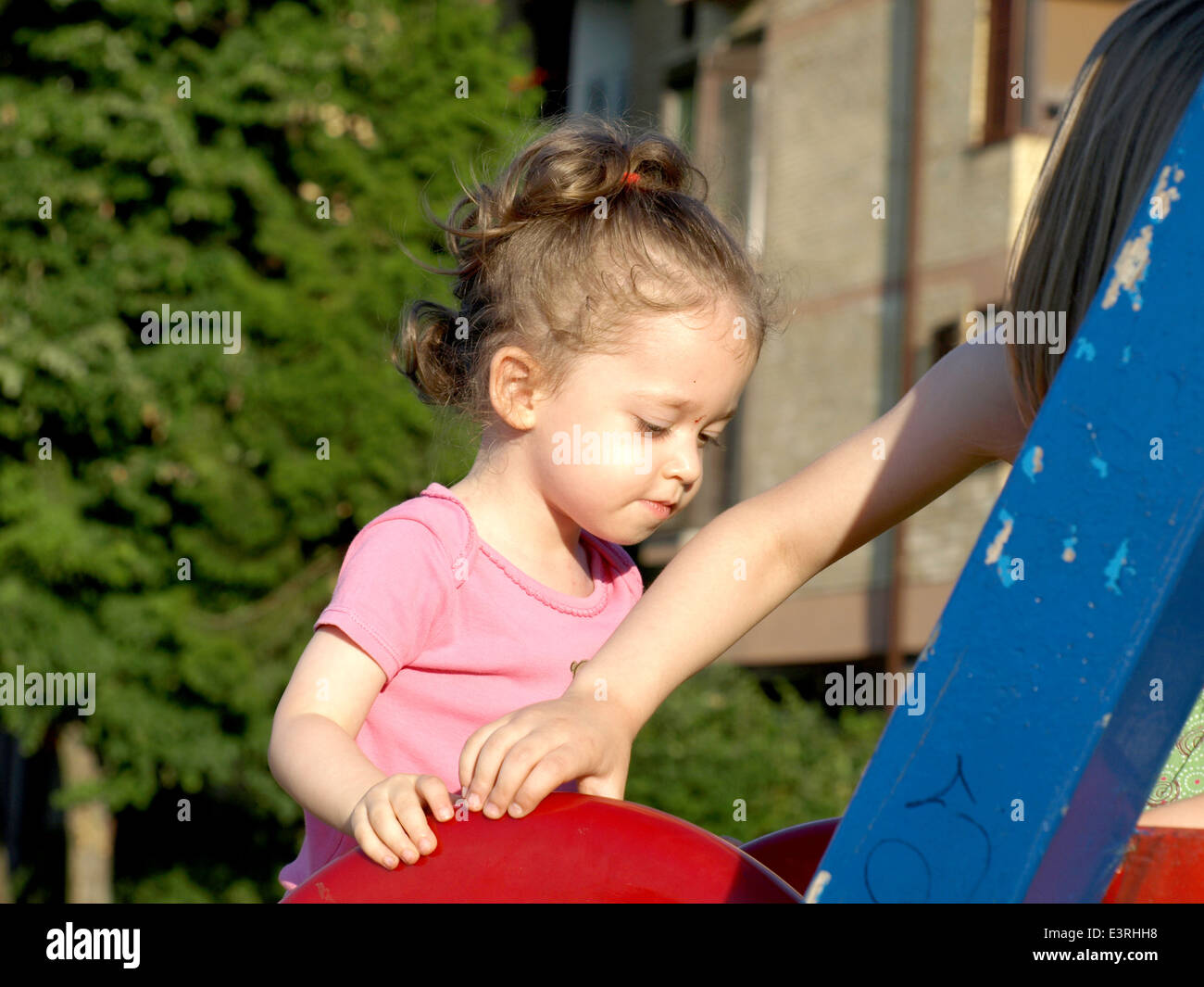 adorable little girl playing in the park Stock Photo - Alamy