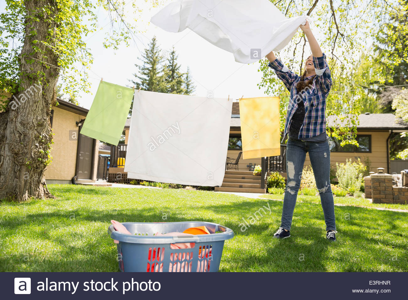 Woman drying cloth from clothesline hires stock photography and images