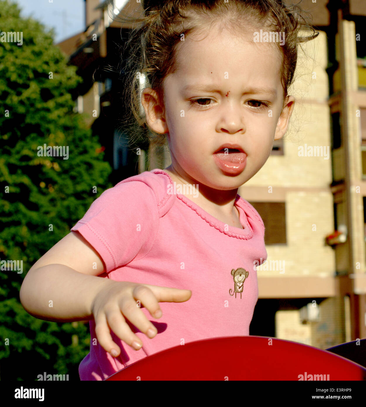 adorable little girl playing in the park Stock Photo - Alamy