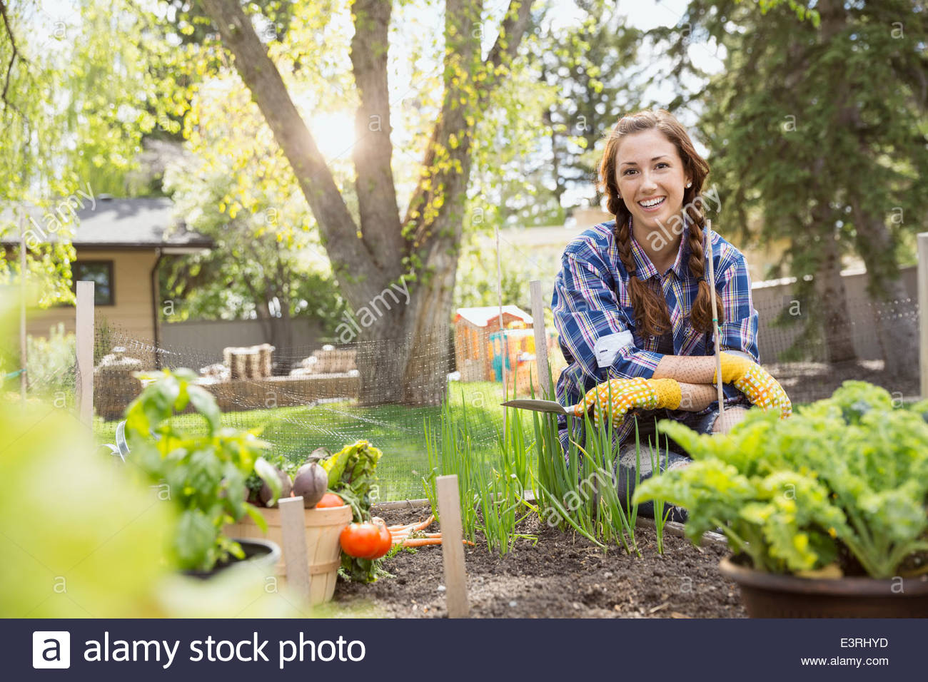 Portrait of smiling woman in vegetable garden Stock Photo - Alamy