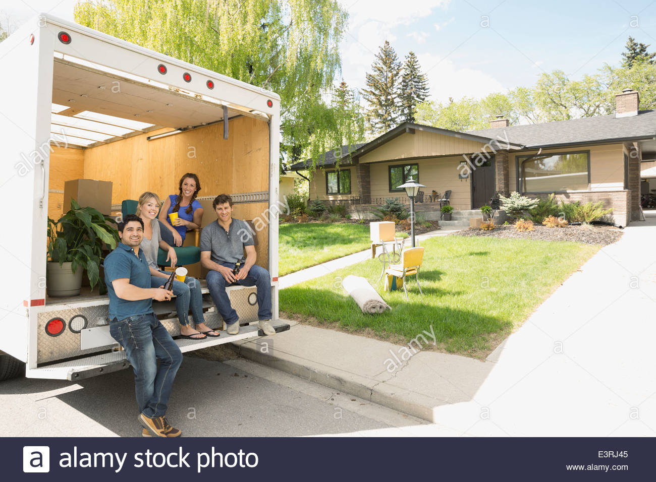 Portrait of couples at back of moving van Stock Photo