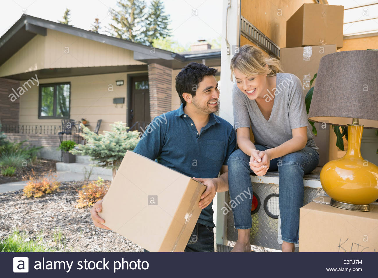 Couple talking at back of moving van Stock Photo