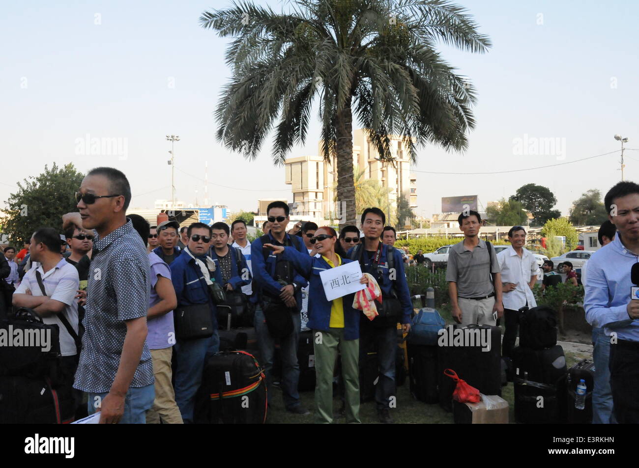 Baghdad, Iraq. 28th June, 2014. Chinese workers arrive at a hotel in Baghdad, Iraq, on June 28, 2014. All of the more than 1,200 Chinese workers trapped in the northern Iraqi city of Samarra have been safely evacuated to the capital Baghdad, according to the Chinese embassy in Baghdad. © Shang Le/Xinhua/Alamy Live News Stock Photo