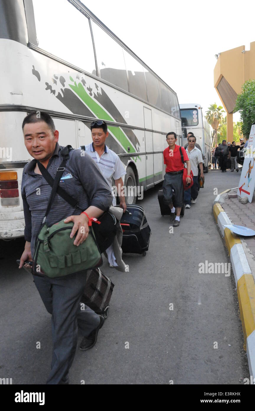 Baghdad, Iraq. 28th June, 2014. Chinese workers arrive in Baghdad, Iraq, on June 28, 2014. All of the more than 1,200 Chinese workers trapped in the northern Iraqi city of Samarra have been safely evacuated to the capital Baghdad, according to the Chinese embassy in Baghdad. © Shang Le/Xinhua/Alamy Live News Stock Photo